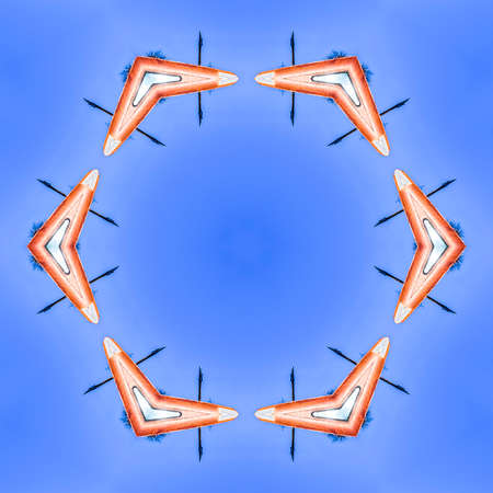 Abstract metal boomerang design made from photo. Geometric kaleidoscope pattern on mirrored axis of...