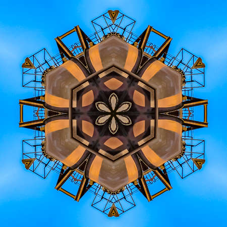 Abstract thick flower made from industrial photo. Geometric kaleidoscope pattern on mirrored axis of...