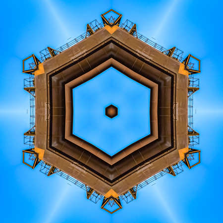 Metallic shape from industrial equipment in photo. Geometric kaleidoscope pattern on mirrored axis...