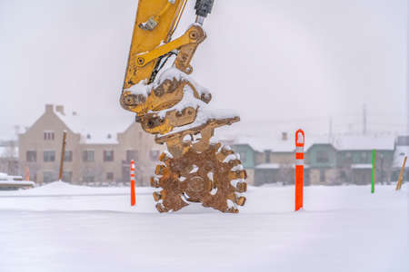 Wheels on the arm of a snowy construction vehicleの写真素材