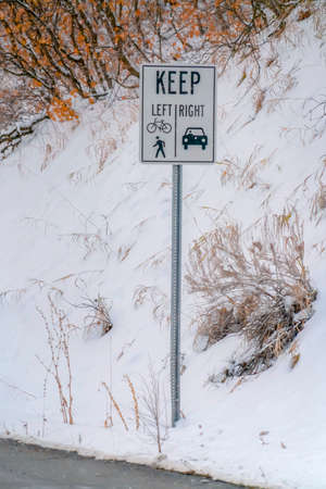 Keep Left and Keep Right sign against snowy slope