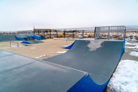 Skateboard ramps with melting snow on the groundの写真素材