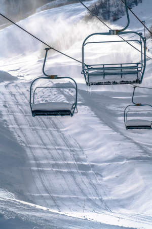 Ski lifts against snow on a sunny day in Park City
