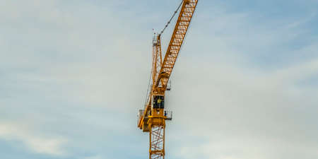 Tower crane with sky and clouds in the background