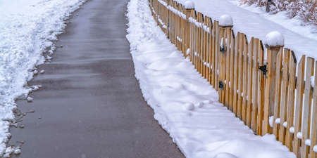 Pavement and fence against snow in Daybreak Utah