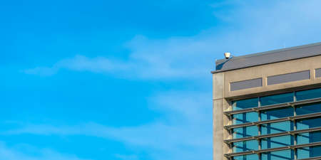 Surveillance video camera at the top of a building