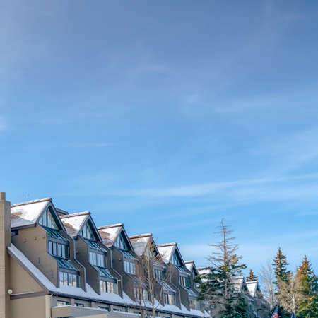 Snowy building against vast sky in Park City Utah. Exterior view of a snow covered building with...