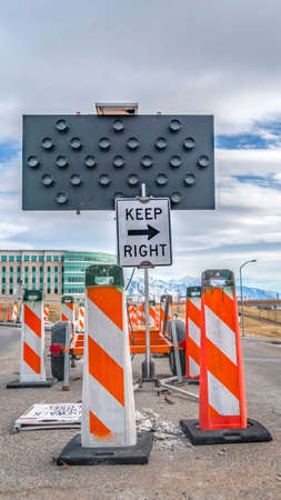 Clear Vertical Keep Right sign and arrow board in the middle of a road under repair