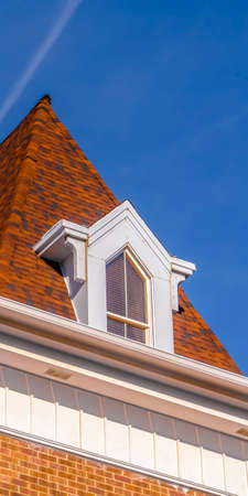 Clear Vertical Roof and steeple of a building with vibrant blue sky in the background