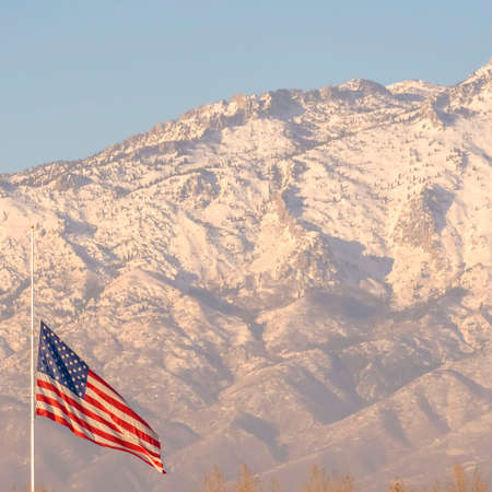 Clear Square American flag and building with Mount Timpanogos and sky in the background