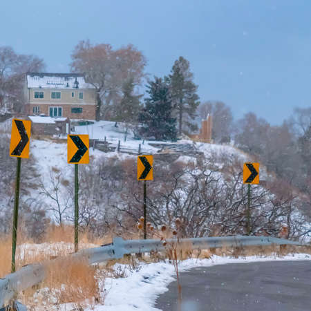 Clear Square Directional road signs against snowy mountain dayの写真素材