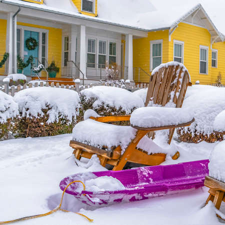Clear Square Daybreak Utah landscape with purple sled and wooden chairs covered in snow