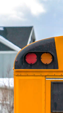 Vertical Close up of the rear of a school bus with a window and several signal lightsの写真素材