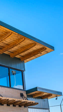 Clear Vertical Exterior of a brick building with flat roof and large glass windowsの写真素材