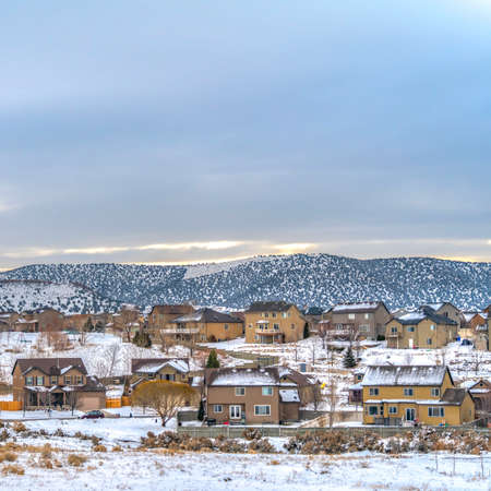 Square Frosty town with homes that contrast with the blanket of snow in winter