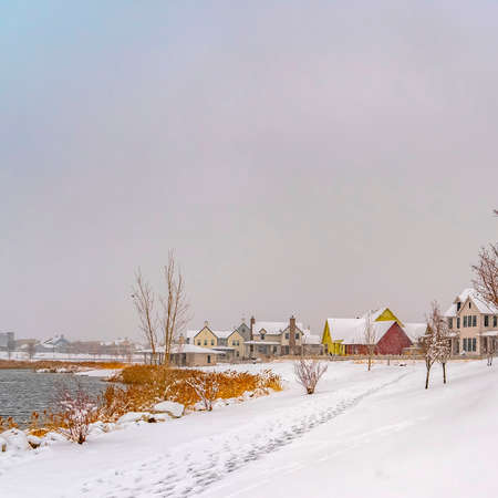 Clear Square Scenic snowy lake landscape in Daybreak Utah. A stunning and scenic snow covered landscape by the Oquirrh Lake in Daybreak, Utah during winter season with view of homes and buildings in the distance.の写真素材