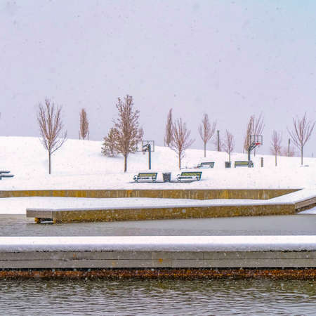 Clear Square Snowy deck and park at a lake in Daybreak Utah. Winter scenery at Oquirrh Lake in...
