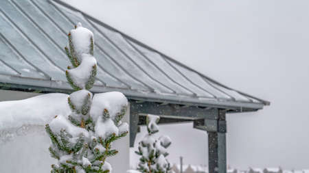 Panorama Snowy tree and pavilion in Daybreak Utah viewed on a cold winter day. Homes against vast...