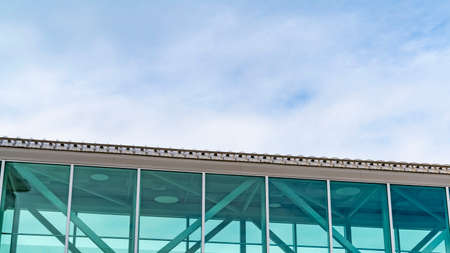 Clear Panorama Looking up at an empty skybridge with a cloudy blue sky in the background. A mountain...
