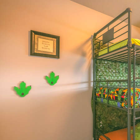 Clear Square Cozy room interior with a colorful triple bunk bed for children. Bright sunlight streams inside the bedroom through the glass window with blinds and multi-colored curtain.の写真素材