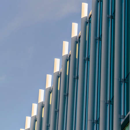 Square Exterior of a modern building with vertical sunshades outside the glass windows