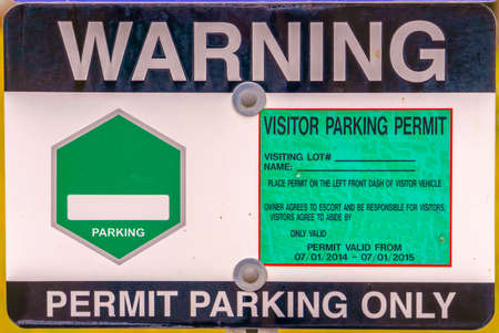 Close up view of a Warning Permit Parking Only sign boardの写真素材