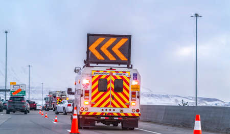 Back view of an emergency vehicle with an arrow board mounted on the roofの写真素材