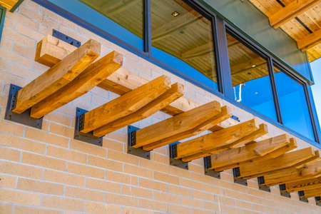 Building with decorative woods extending horizontally from the brick wall