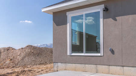 Panorama Exterior view of a house under construction against pale blue sky