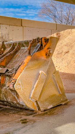 Vertical frame Bucket of a heavy duty machinery at a construction site on a sunny day