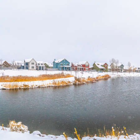 Frame Square Silvery lake amid a scenic landscape blanketed with fresh snow in winterの写真素材