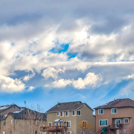 Frame Square Houses on a hill covered with powdery white snow during winter seasonの写真素材