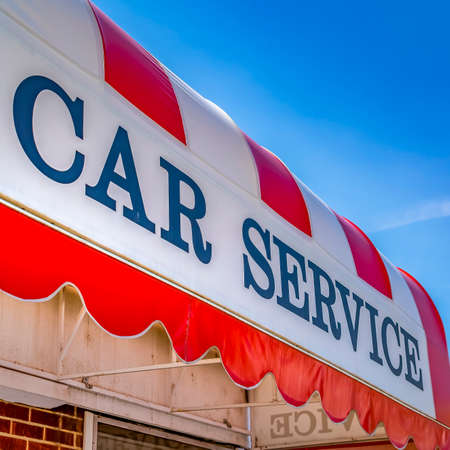 Frame Square Car Service sign on the curved awning of a commercial brick buildingの写真素材