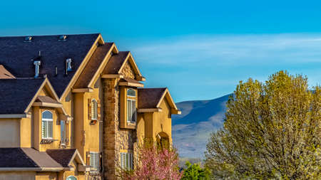 Panorama Exterior of lavish house with mountain and blue sky background on a sunny dayの写真素材