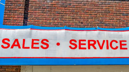 Panorama frame A huge sign that reads Sales Service Parts outside a commercial buildingの写真素材