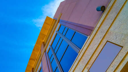 Panorama frame Commercial building exterior with cylindrical wall lights and blue windows