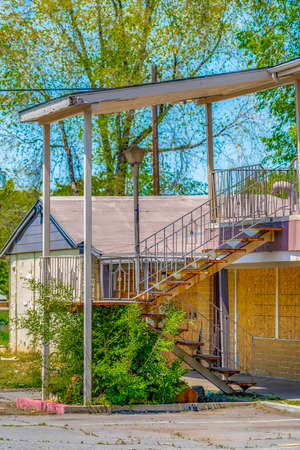 Facade of a home with stairs leading to the balcony and upper floor entranceの写真素材