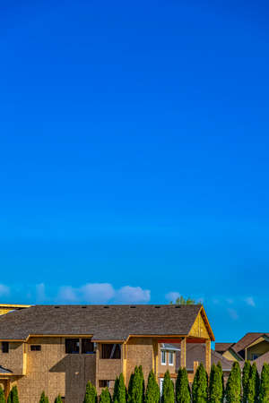 Exterior of a house under construction with blue sky background on a sunny dayの写真素材