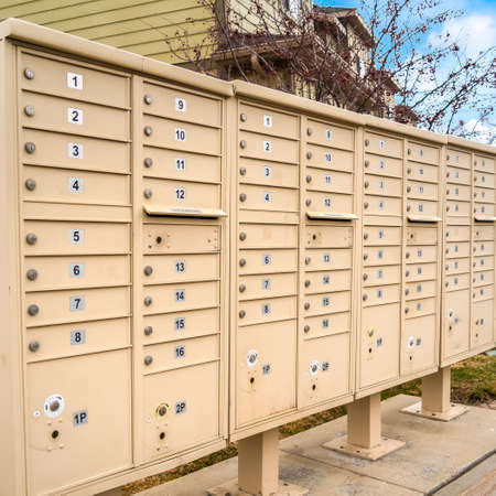 Square Residential mailboxes with numbered compartments on the side of a roadの写真素材