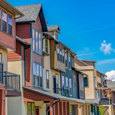 Square frame Bright sunlight beaming down on the row of houses with small balconies