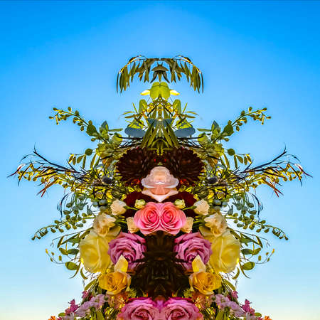 Leaves and roses in colorful floral design. Geometric kaleidoscope pattern on mirrored axis of...