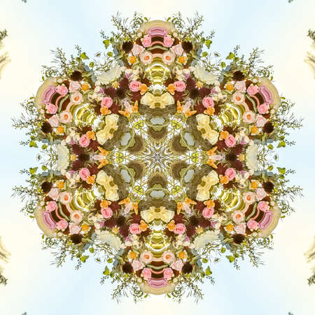 Floral design into a kaleidoscopic shape with multiple types of flowers for a design. Geometric...