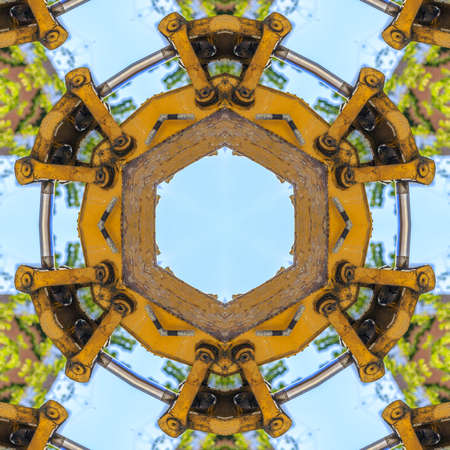 Circular geometric shape made from tractor. Geometric kaleidoscope pattern on mirrored axis of symmetry reflection. Colorful shapes as a wallpaper for advertising background or backdrop.の写真素材