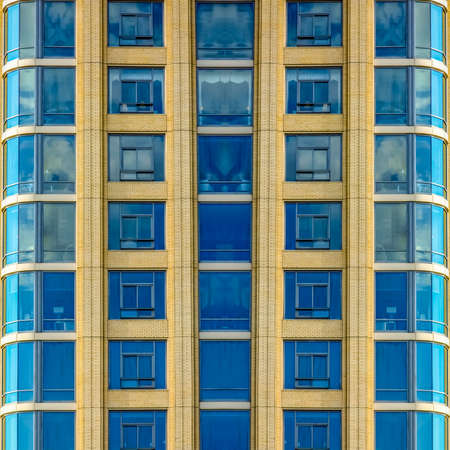 Close up of windows and decks of apartment. Geometric kaleidoscope pattern on mirrored axis of symmetry reflection. Colorful shapes as a wallpaper for advertising background or backdrop.の写真素材