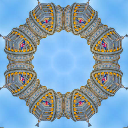 Circle made with decorative facade of capital. Geometric kaleidoscope pattern on mirrored axis of symmetry reflection. Colorful shapes as a wallpaper for advertising background or backdrop.の写真素材