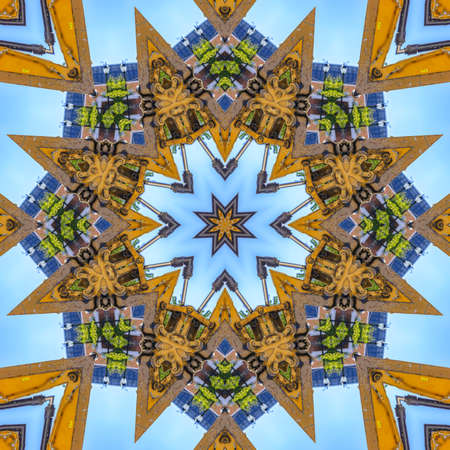 Tractor arm made into a decorative design. Geometric kaleidoscope pattern on mirrored axis of symmetry reflection. Colorful shapes as a wallpaper for advertising background or backdrop.の写真素材