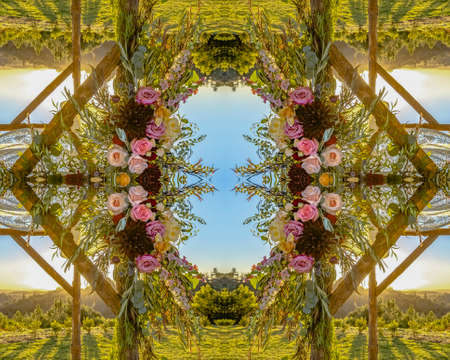 Reflective symmetrical view of Chuppah with flowers in circular arrangement at wedding in...
