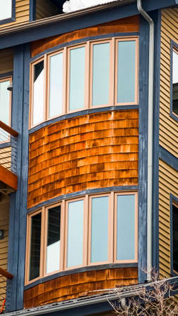 Vertical frame Close up of residential building exterior with horizontal siding and balconies
