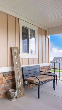 Vertical frame Entrance of a home with porch and glass paned wooden front door