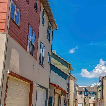 Square Rows of houses with paved road in the middle under blue sky on a sunny day